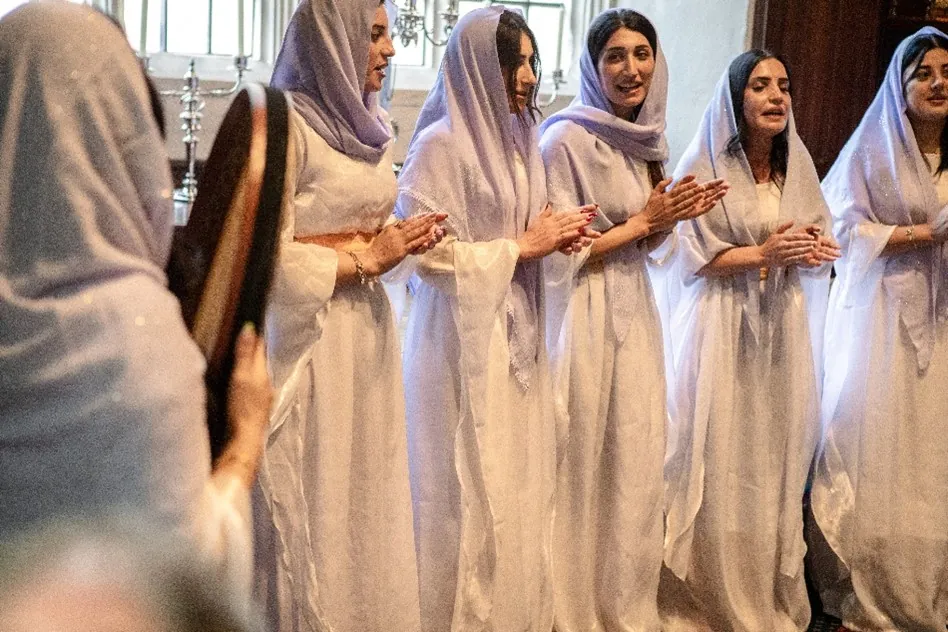 Members of the AMAR Yazidi Ladies Peace Choir in traditional white dress