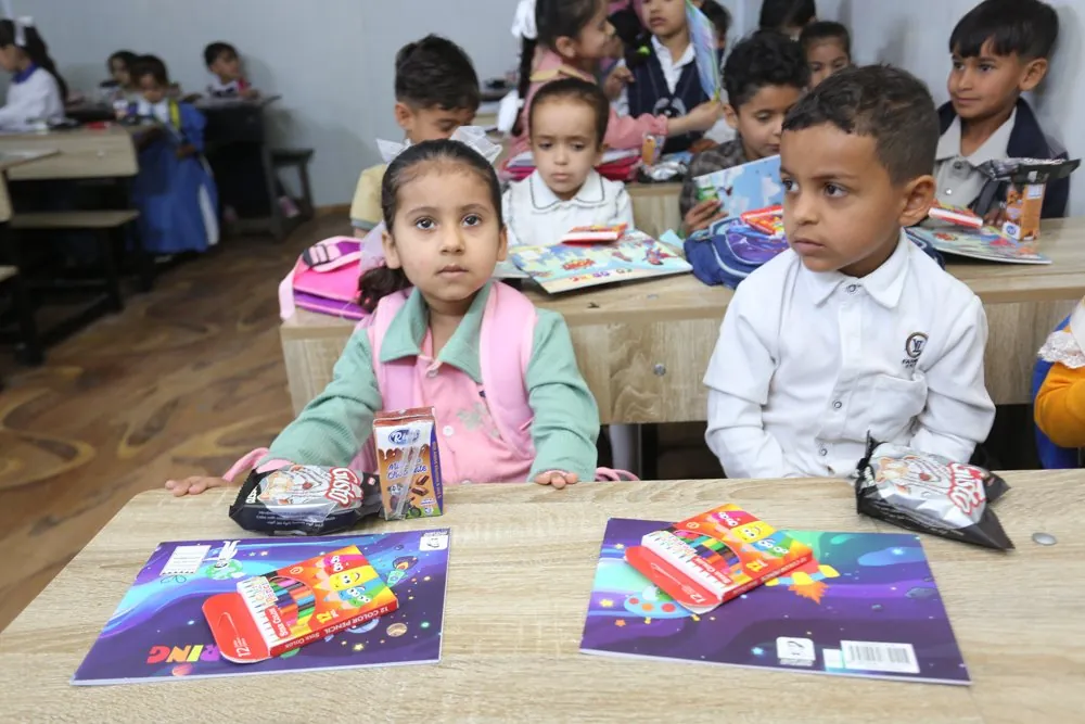 Children with new books at an AMAR centre