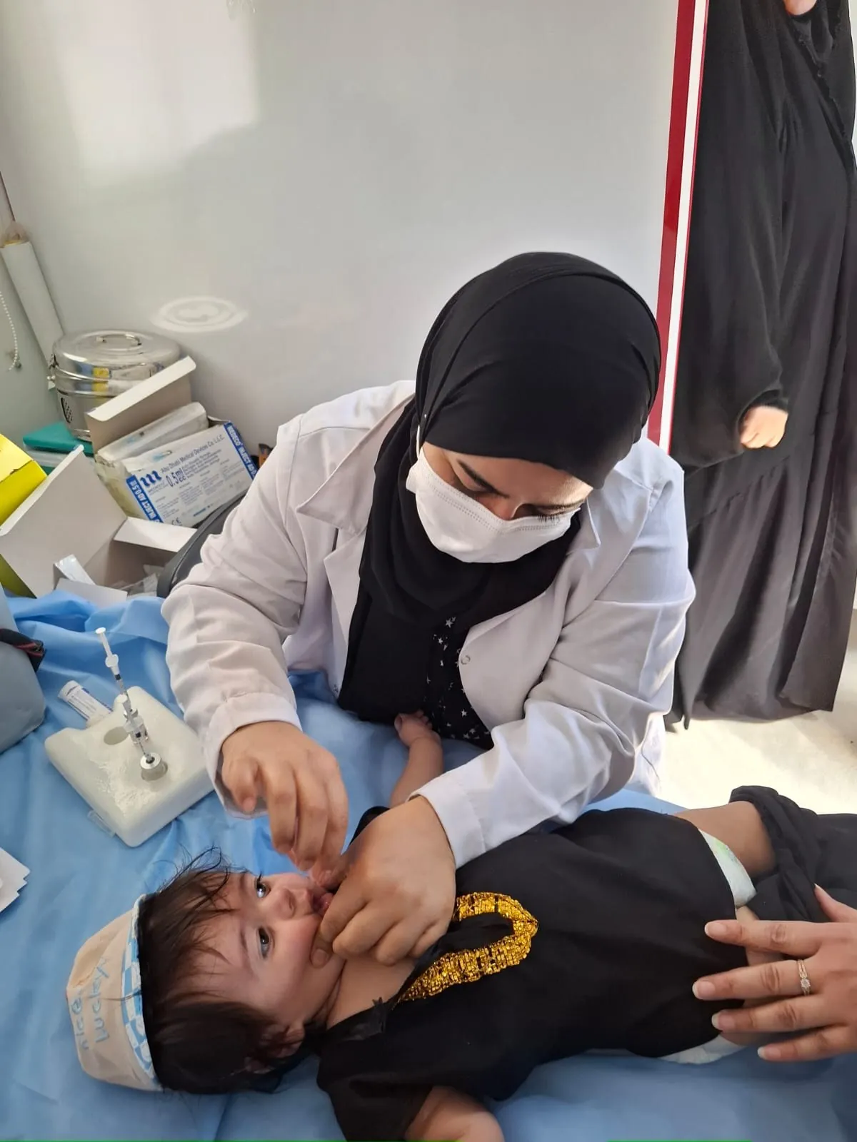 A nurse examines an infant at the AMAR mobile health clinic