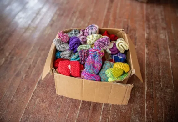 Hand-knitted hats ready for distribution